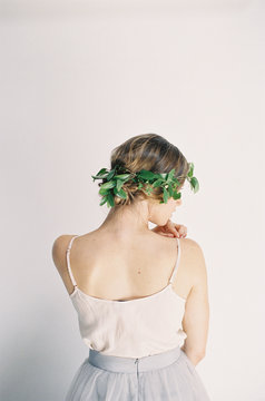 Woman wearing leaf crown, rear view