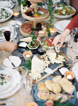 Guests taking food from buffet table, mid section
