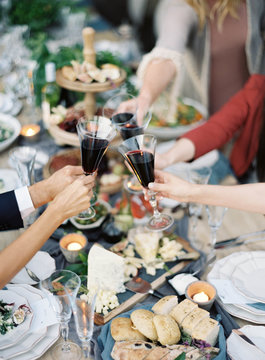 Guests making toast over buffet table, mid section