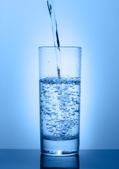 Beautiful glass with water on a blue background
