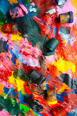 Boxes and oil paints multicolored closeup abstract background fr