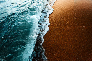 Sea surf on waters edge