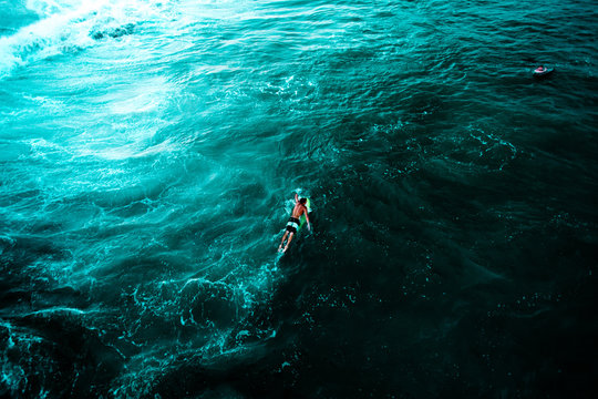 Person floating on water surface, view from above