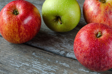Red and green apples with drops of dew.