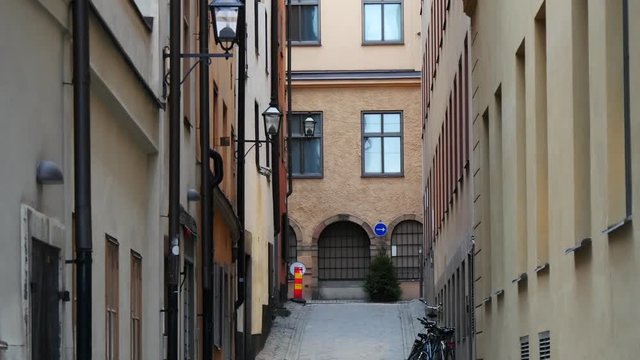 Panning view of the rising narrow paved street in old town Gamla Stan, Stockholm, Sweden