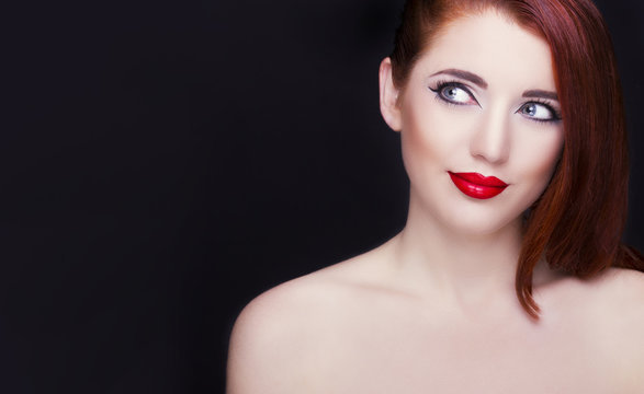 Portrait of beautiful redhead woman. Perfect makeup.