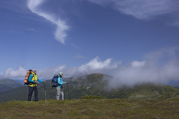 Obraz premium Summer hiking in the mountains with a backpack .