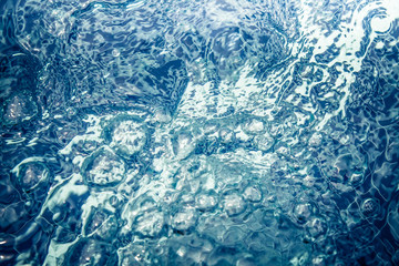 toned clear water whirlpool with bubbles and ripples