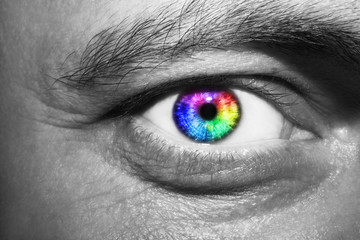 Image of man's rainbow eye close up.