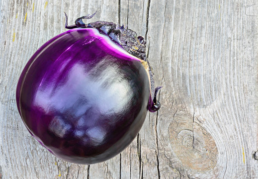 Violet eggplant on a old wooden table