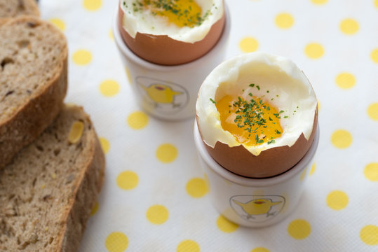 Soft boiled eggs on white yellow dotted napkin. Closeup detail