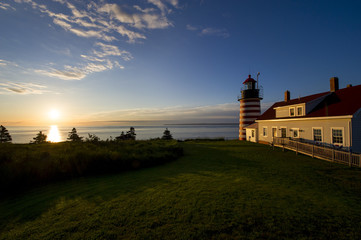 A colorful sunrise behind West Quoddy Head Light in Lubec Maine.