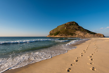 Fototapeta na wymiar Footsteps in Sand in Recreio Beach and Pontal Rock in the Ocean