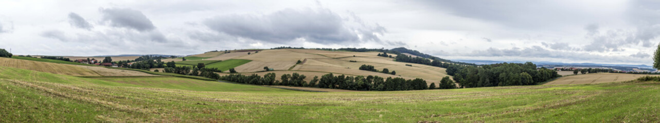 Fototapeta na wymiar Rural landscape with fields and clouds near Felsberg