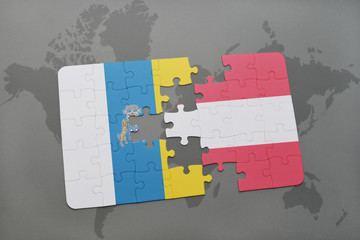 puzzle with the national flag of canary islands and austria on a world map background.
