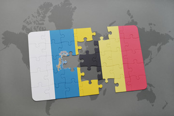 puzzle with the national flag of canary islands and belgium on a world map background.