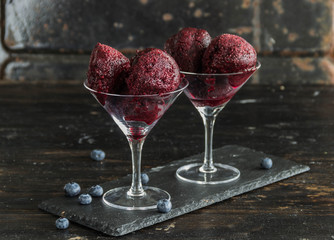 Homemade blueberry ice cream scoops with fresh berries
