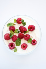 Red Raspberries in bowl of Yoghurt
