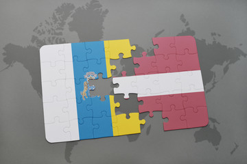 puzzle with the national flag of canary islands and latvia on a world map background.