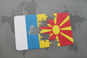 puzzle with the national flag of canary islands and macedonia on a world map background.