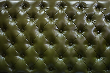 Vintage cobalt green leather upholstery buttoned sofa (background)