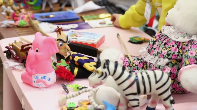 Many toys lying on table, children playing games at kindergarten or orphan home