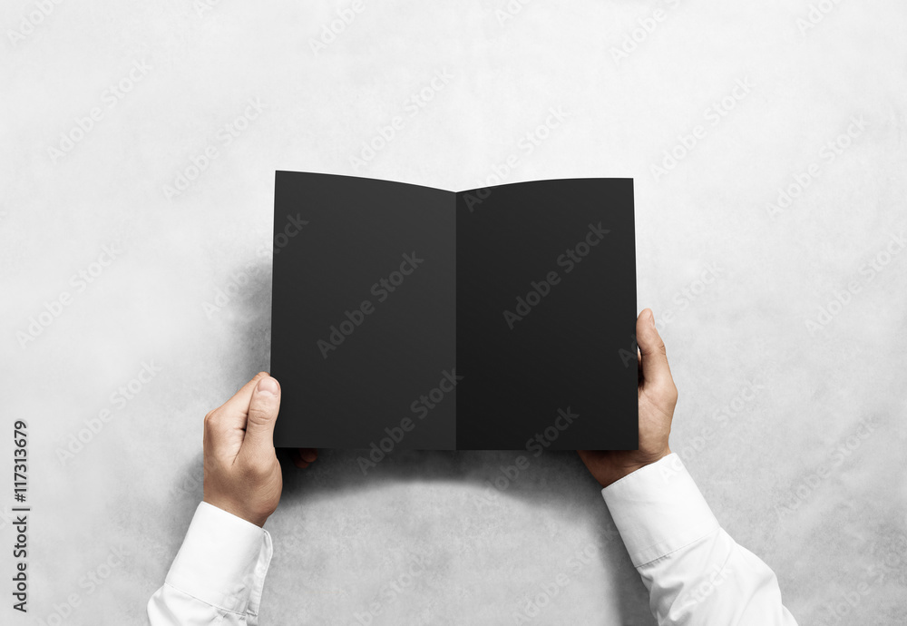 Poster hand opening blank black brochure booklet mockup. leaflet presentation. pamphlet mock up holding han