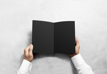 Hand opening blank black brochure booklet mockup. Leaflet presentation. Pamphlet mock up holding hand. Man show clear offset paper. Booklet design template. A5 paper sheet display read first person