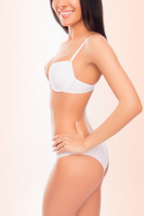 Fototapeta na wymiar Close up of young happy woman with perfect body in white underw