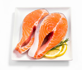 Two slices of salmon steak with lemon