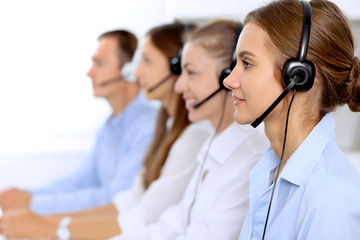 Young beautiful business woman in headset. Call center operator.