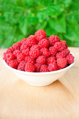 Ripe red raspberries in a bowl