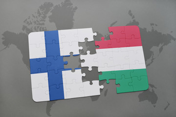 puzzle with the national flag of finland and hungary on a world map background.