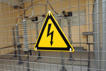 Yellow triangular sign of electrical hazards.