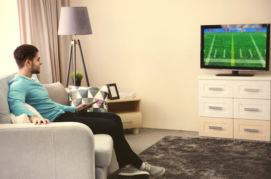 Man Watching Football Game On Tv At Home.