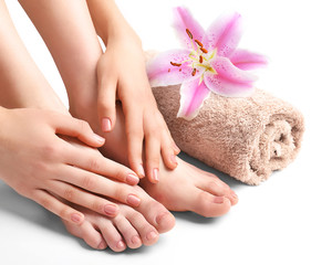 Female feet with flowers on white background