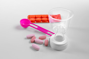Drugs and soother on white background