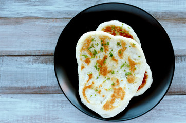 Flat lay view of traditional Indian Naan flatbread