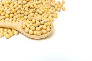 Soybeans in a wooden spoon isolated on a white background,closeup