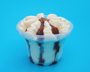side view cup of chocolate flavor ice cream on blue background