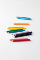 Bunch of fun mini colored pencils isolated on white. Group of wooden pencils