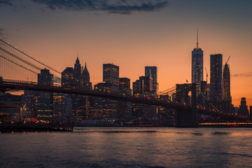 Panorama of Brooklyn Bridge and Manhattan skyline on a clear evening