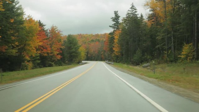 Driving on the Kancamagus Highway in the White Mountains of New Hampshire in Autumn.