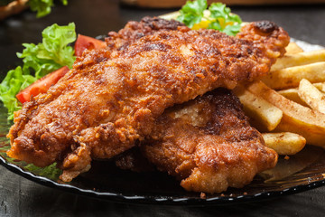 Fried fish in crispy batter with chips