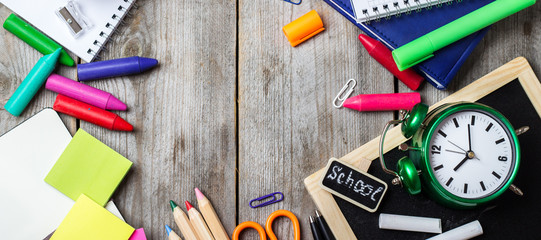 Assortment of office and school supplies on wooden table