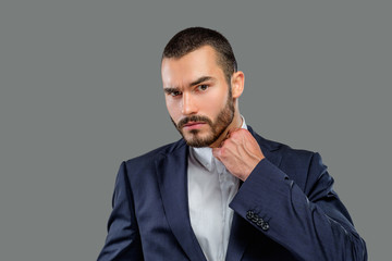 Portrait of bearded male in a suit.