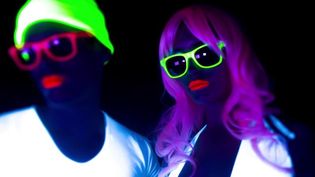 cyber raver couple in fluorescent UV glow