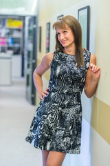Beautiful Russian girl posing in office hall against the wall