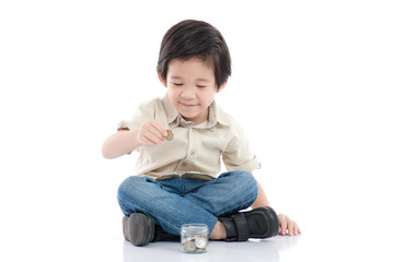 Cute Asian child saving money in glass bottle,money saving concept