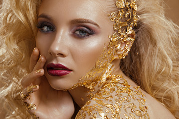 Beauty woman ,  blond  hair , professional make-up , gold color.